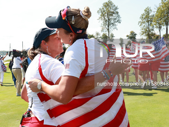 GAINESVILLE, VIRGINIA - SEPTEMBER 15: Lexi Thompson of the United States hugs Vice Captain Angela Stanford after a Team USA win the Solheim...