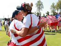 GAINESVILLE, VIRGINIA - SEPTEMBER 15: Lexi Thompson of the United States hugs Vice Captain Angela Stanford after a Team USA win the Solheim...