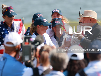 GAINESVILLE, VIRGINIA - SEPTEMBER 15: John Solheim representing the Solheim family presents Staycy Lewis of the United States with the troph...