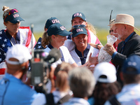 GAINESVILLE, VIRGINIA - SEPTEMBER 15: John Solheim representing the Solheim family presents Staycy Lewis of the United States with the troph...