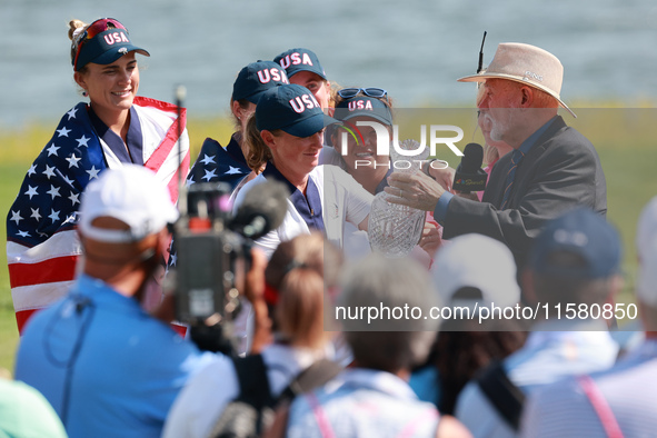 GAINESVILLE, VIRGINIA - SEPTEMBER 15: John Solheim representing the Solheim family presents Staycy Lewis of the United States with the troph...