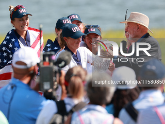 GAINESVILLE, VIRGINIA - SEPTEMBER 15: John Solheim representing the Solheim family presents Staycy Lewis of the United States with the troph...