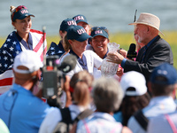 GAINESVILLE, VIRGINIA - SEPTEMBER 15: John Solheim representing the Solheim family presents Staycy Lewis of the United States with the troph...