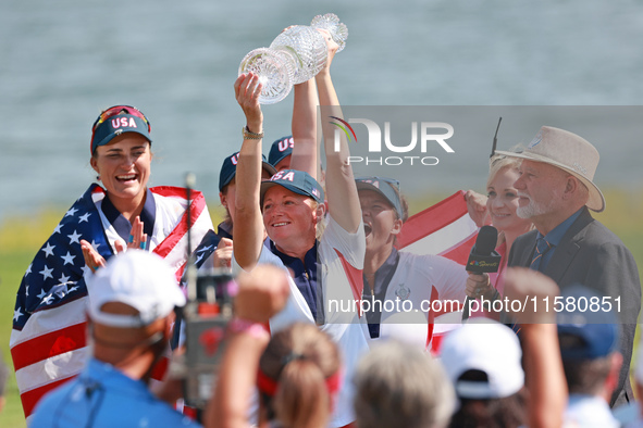 GAINESVILLE, VIRGINIA - SEPTEMBER 15: Captain Stacy Lewis of the United States holds up the trophy after a Team USA win the Solheim Cup at R...