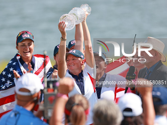 GAINESVILLE, VIRGINIA - SEPTEMBER 15: Captain Stacy Lewis of the United States holds up the trophy after a Team USA win the Solheim Cup at R...