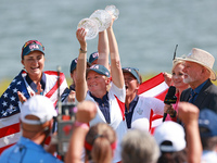 GAINESVILLE, VIRGINIA - SEPTEMBER 15: Captain Stacy Lewis of the United States holds up the trophy after a Team USA win the Solheim Cup at R...