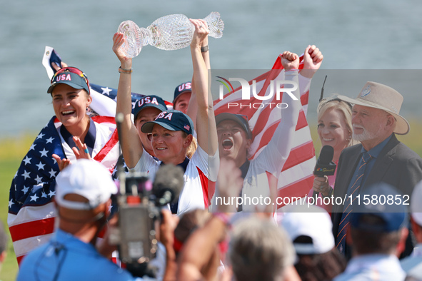 GAINESVILLE, VIRGINIA - SEPTEMBER 15: Captain Stacy Lewis of the United States holds up the trophy after a Team USA win the Solheim Cup at R...