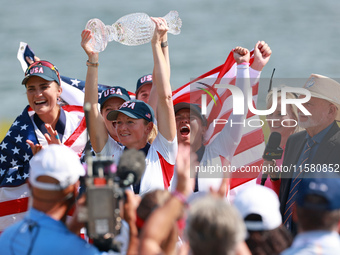 GAINESVILLE, VIRGINIA - SEPTEMBER 15: Captain Stacy Lewis of the United States holds up the trophy after a Team USA win the Solheim Cup at R...