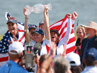 GAINESVILLE, VIRGINIA - SEPTEMBER 15: Captain Stacy Lewis of the United States holds up the trophy after a Team USA win the Solheim Cup at R...