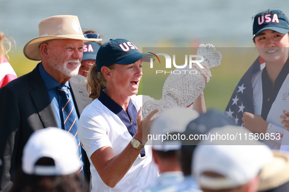 GAINESVILLE, VIRGINIA - SEPTEMBER 15: Captain Stacy Lewis of the United States holds up the trophy after a Team USA win the Solheim Cup at R...