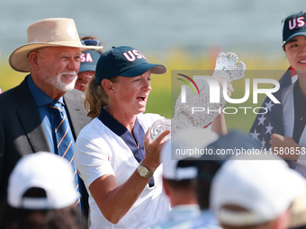 GAINESVILLE, VIRGINIA - SEPTEMBER 15: Captain Stacy Lewis of the United States holds up the trophy after a Team USA win the Solheim Cup at R...