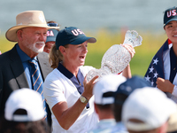 GAINESVILLE, VIRGINIA - SEPTEMBER 15: Captain Stacy Lewis of the United States holds up the trophy after a Team USA win the Solheim Cup at R...