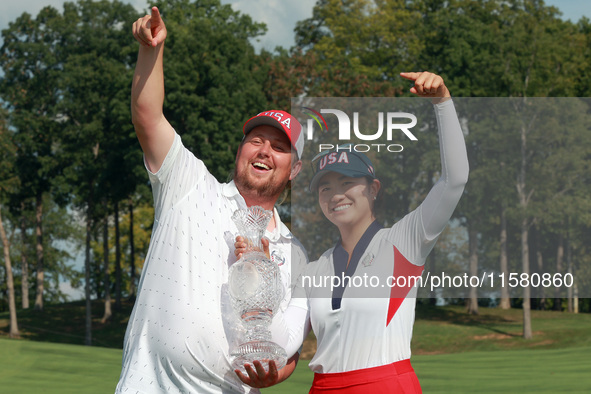 GAINESVILLE, VIRGINIA - SEPTEMBER 15: Rose Zhang of the United States poses with her caddie while holding the trophy after a Team USA win at...