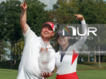 GAINESVILLE, VIRGINIA - SEPTEMBER 15: Rose Zhang of the United States poses with her caddie while holding the trophy after a Team USA win at...