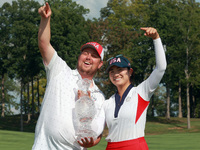 GAINESVILLE, VIRGINIA - SEPTEMBER 15: Rose Zhang of the United States poses with her caddie while holding the trophy after a Team USA win at...