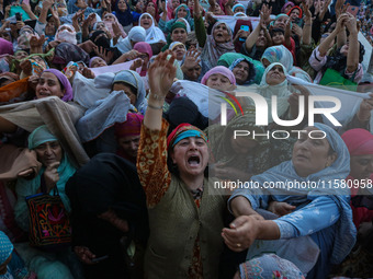 Muslim devotees react as a priest displays a relic believed to be a hair from the beard of Islam's Prophet Muhammad during a gathering organ...