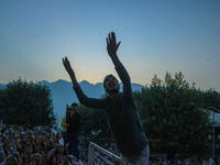 A Kashmiri Muslim devotee prays as a priest displays a relic believed to be a hair from the beard of Islam's Prophet Muhammad during a gathe...