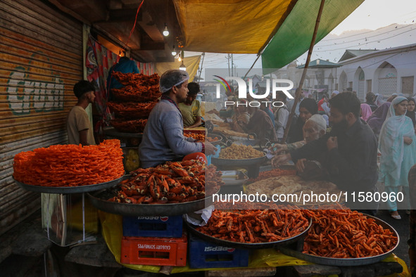 People buy snacks and pudding during a gathering organized on the occasion of Eid Milad-un-Nabi, also known as Mawlid, which marks the birth...