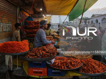 People buy snacks and pudding during a gathering organized on the occasion of Eid Milad-un-Nabi, also known as Mawlid, which marks the birth...