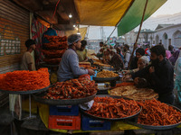 People buy snacks and pudding during a gathering organized on the occasion of Eid Milad-un-Nabi, also known as Mawlid, which marks the birth...