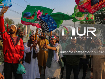 Kashmiri Muslims shout slogans during a rally on the occasion of Eid Milad-un-Nabi, also known as Mawlid, which marks the birth anniversary...