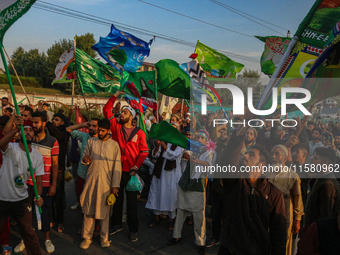 Kashmiri Muslims shout slogans during a rally on the occasion of Eid Milad-un-Nabi, also known as Mawlid, which marks the birth anniversary...