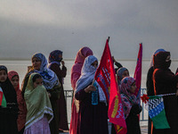 Kashmiri Muslim women watch a rally on the occasion of Eid Milad-un-Nabi, also known as Mawlid, which marks the birth anniversary of the Pro...