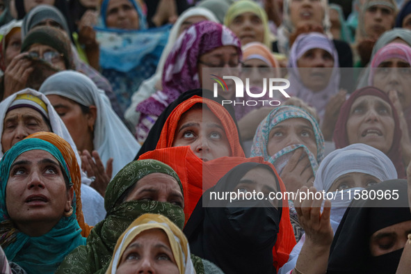 Muslim devotees react as a priest displays a relic believed to be a hair from the beard of Islam's Prophet Muhammad during a gathering organ...