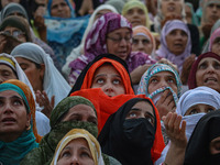 Muslim devotees react as a priest displays a relic believed to be a hair from the beard of Islam's Prophet Muhammad during a gathering organ...