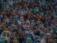 Muslim devotees react as a priest displays a relic believed to be a hair from the beard of Islam's Prophet Muhammad during a gathering organ...