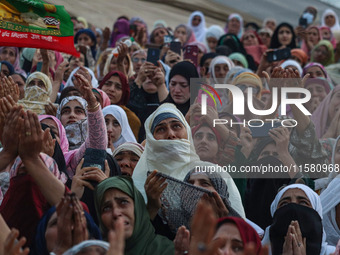 Muslim devotees react as a priest displays a relic believed to be a hair from the beard of Islam's Prophet Muhammad during a gathering organ...