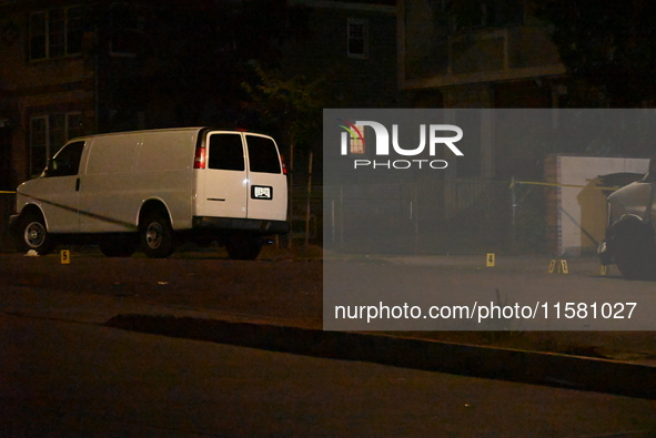 Crime scene investigators collect evidence, mark evidence with evidence markers, and inspect the vehicle airbag with blood on it from the vi...