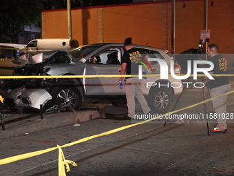 Crime scene investigators collect evidence, mark evidence with evidence markers, and inspect the vehicle airbag with blood on it from the vi...