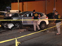 Crime scene investigators collect evidence, mark evidence with evidence markers, and inspect the vehicle airbag with blood on it from the vi...