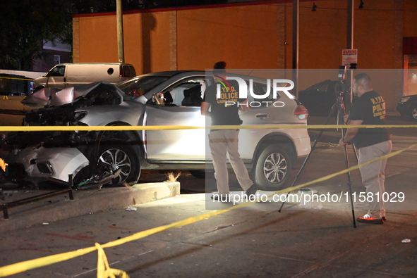 Crime scene investigators collect evidence, mark evidence with evidence markers, and inspect the vehicle airbag with blood on it from the vi...