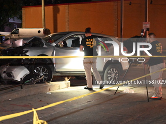 Crime scene investigators collect evidence, mark evidence with evidence markers, and inspect the vehicle airbag with blood on it from the vi...