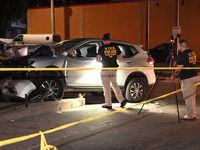 Crime scene investigators collect evidence, mark evidence with evidence markers, and inspect the vehicle airbag with blood on it from the vi...