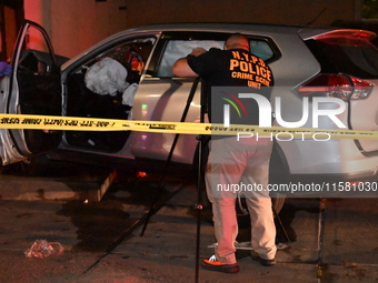 Crime scene investigators collect evidence, mark evidence with evidence markers, and inspect the vehicle airbag with blood on it from the vi...