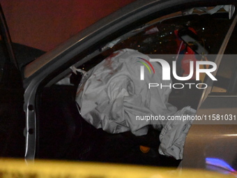 Crime scene investigators collect evidence, mark evidence with evidence markers, and inspect the vehicle airbag with blood on it from the vi...