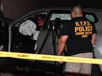 Crime scene investigators collect evidence, mark evidence with evidence markers, and inspect the vehicle airbag with blood on it from the vi...