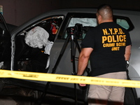 Crime scene investigators collect evidence, mark evidence with evidence markers, and inspect the vehicle airbag with blood on it from the vi...