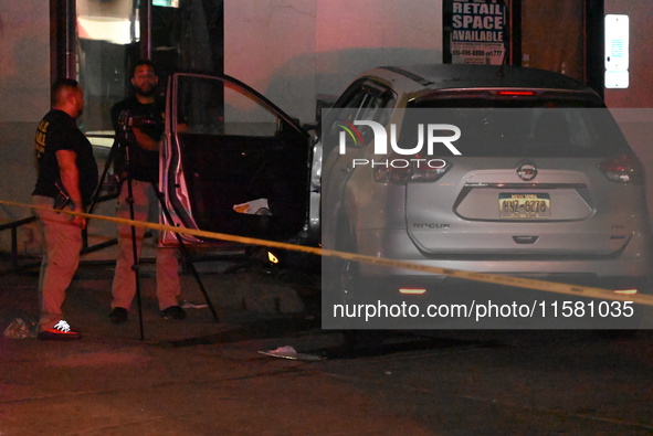 Crime scene investigators collect evidence, mark evidence with evidence markers, and inspect the vehicle airbag with blood on it from the vi...