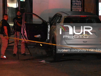 Crime scene investigators collect evidence, mark evidence with evidence markers, and inspect the vehicle airbag with blood on it from the vi...