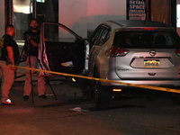 Crime scene investigators collect evidence, mark evidence with evidence markers, and inspect the vehicle airbag with blood on it from the vi...