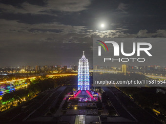 A supermoon appears over the Porcelain Tower of Nanjing in Nanjing, China, on September 17, 2024. (