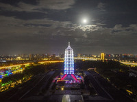 A supermoon appears over the Porcelain Tower of Nanjing in Nanjing, China, on September 17, 2024. (