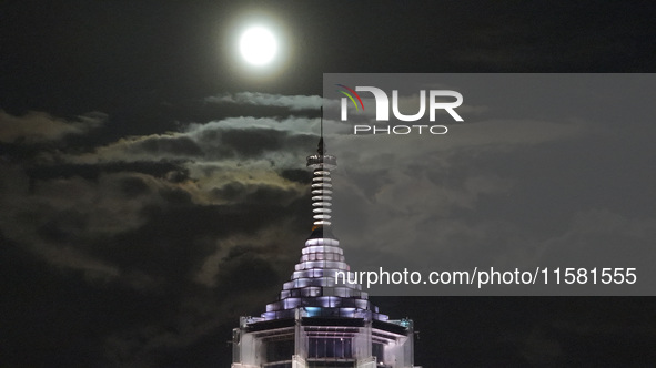 A supermoon appears over the Porcelain Tower of Nanjing in Nanjing, China, on September 17, 2024. 