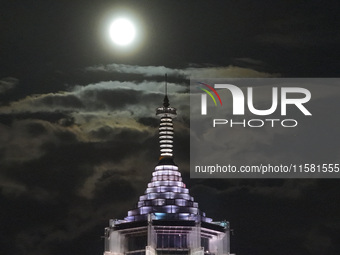 A supermoon appears over the Porcelain Tower of Nanjing in Nanjing, China, on September 17, 2024. (