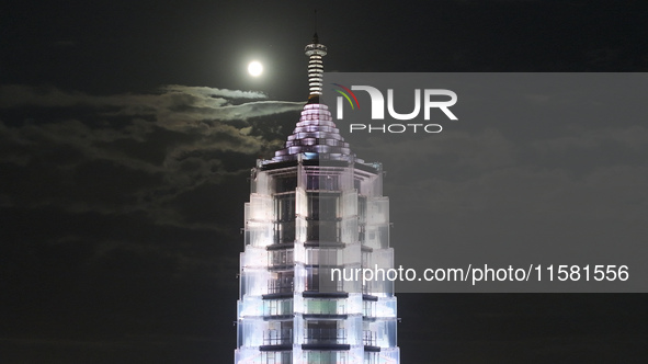 A supermoon appears over the Porcelain Tower of Nanjing in Nanjing, China, on September 17, 2024. 