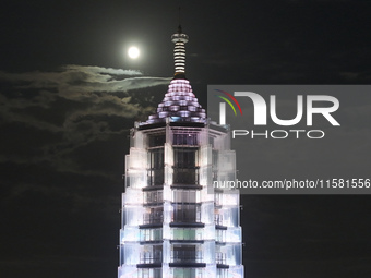 A supermoon appears over the Porcelain Tower of Nanjing in Nanjing, China, on September 17, 2024. (